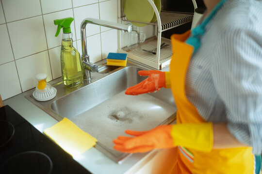 Frustrated woman facing a clogged kitchen sink