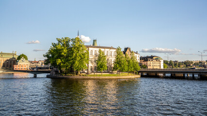 Lush green island with historic buildings and bridges in Stockholm