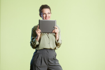 Woman with tablet in green setting