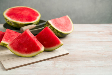 Slices of fresh watermelon on bright rustic wooden table, copy space