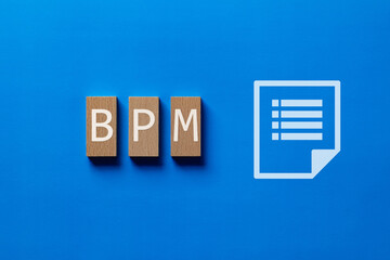 There is wood block with the word BPM. It is an abbreviation for Business Process Management as...