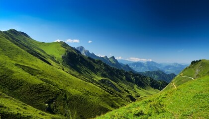 Obraz premium mountain landscape with lush green hillside under clear blue sky