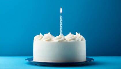 white cake with one lit birthday candle on a blue background
