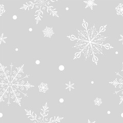 Christmas seamless pattern with big and small intricate snowflakes in various designs and small circles, white on gray background.