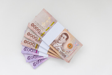 Banknote thai baht, paper bank, price of one thousand, stacked sets isolated on white background. 1000, 500 Bath bank note for shopping, paying bills, taxes, debt, insurance, financial, investment.