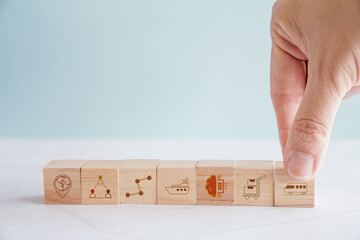 Hands holding wooden blocks with logistic icons, supply chain management, logistics tech , business...