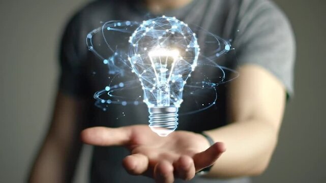 Digital Light Bulb Floating Above Hand Representing Innovation and Technology
