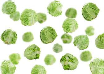 Fresh ripe cabbages falling on white background