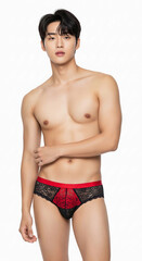 Fototapeta premium A bold expression of gender identity and fetish fashion—male model poses in lace lingerie and thigh-highs, embracing kink, body positivity, and modern masculinity with fearless confidence. 