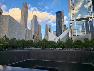 New York, United States - May 29, 2025: Memorial reflecting pool surrounded by skyscrapers in Lower Manhattan, showcasing the architectural beauty and solemn atmosphere of the 9/11 Memorial site