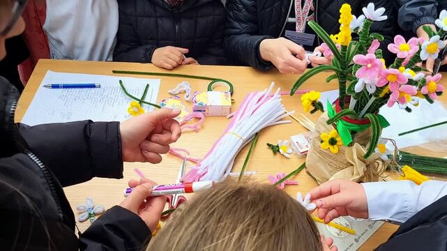 Creative craft session on making colorful flower arrangements with children in community center for the festival fairs