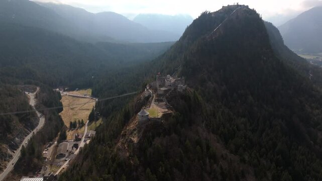 Aerial view of Ehrenberg Castle complex near Reutte, Tyrol, Austria. The medieval Ehrenberg ruins, Schlosskopf Fortress, and the iconic highline179 suspension bridge set in the stunning Lechtal Alps. 