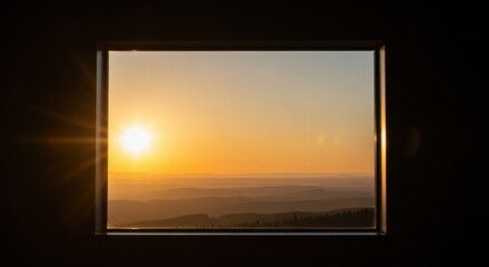 Golden Hour Sunburst View Through a Dark Window Frame Over Rolling Hills