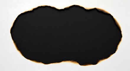 Burned hole in white paper with charred edges, revealing a dark void.