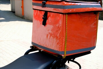 A courier delivers a food package order. Fast package service. Delivery man box and helmet...