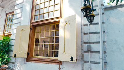 Tall windows and wide openings with typical colonial architecture in old city buildings