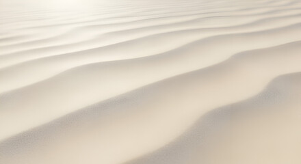 Obraz premium A minimalist background of serene sand dunes with soft light, showcasing natural wave-like texture and tranquil patterns.