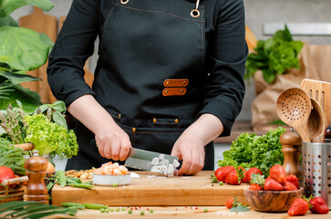 chef skillfully chopping onion, vegetables and arranging fresh ingredients on a cutting board in a vibrant kitchen setting.