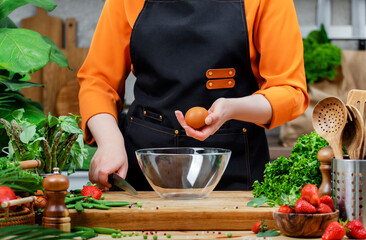 Healthy cooking with fresh vegetables and eggs by a passionate chef in a vibrant kitchen filled with greenery and culinary tools