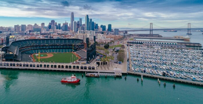 Aerial view of a San Francisco Fire Department boat patrolling the waters near Oracle Park and a marina in San Francisco, California, USA.