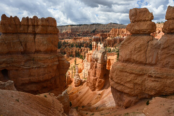 Looking out from the Queens Garden Trail at red rock hoodoo formations in Bryce Canyon National...