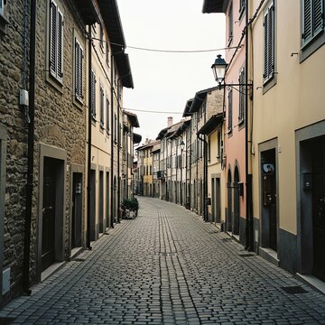 Fototapeta Cobblestone street in Italian town