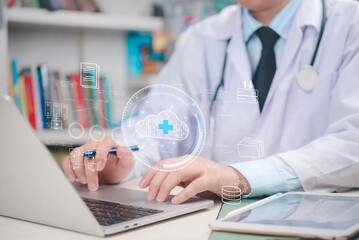 Doctor working on laptop with virtual cloud icons and healthcare data, cloud computing in the...