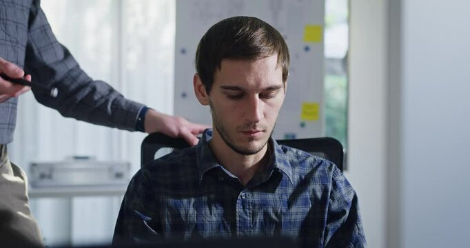 Closeup team adult male engineer collaborate on robotic hand project using AI code solutions machine learning at tech workspace. Artificial intelligence interface, collaboration prototype development.