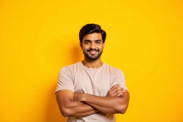 Fototapeta premium A man smiles confidently against a bright yellow background.