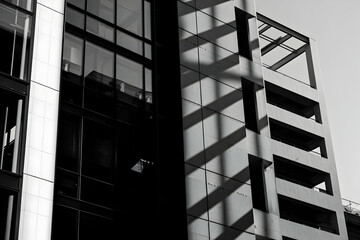 Obraz premium Abstract Architectural Shadows on Modern Building Facade in Black White