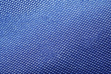 Abstract blue textured surface, featuring a close-up pattern and aesthetic design. The textile boasts a grid of squares, presenting a sleek, repeating structure