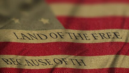 Vintage national flag of the United States of America waving in the wind with "Land of the free because of the brave" text animation. Concept of 4th of july, independence day, memorial, patriotic