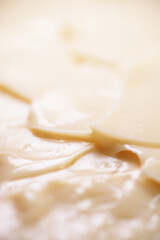 Mayonnaise is an emulsion of oil, egg yolk, and an acid, either vinegar or lemon juice