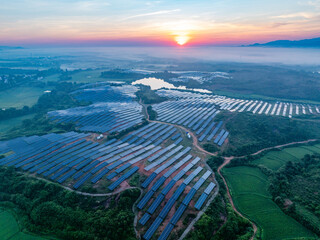 Photovoltaic panels on a hillside at sunrise