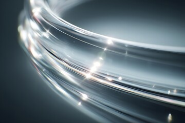 An abstract image of fiber optic cables with glowing strands, showcasing modern technology. The light illuminates the transparent material
