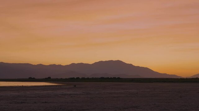 Aerial view of a dramatic glowing sky over the Salton Sea with smokey clouds from wildfires.