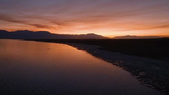 Aerial view of a dramatic glowing sky over the Salton Sea with smokey clouds from wildfires.