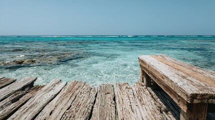 Fototapeta premium Wooden pier extending into a turquoise ocean.