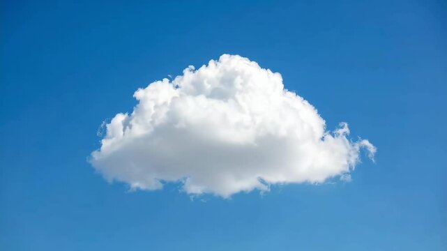 Single puffy cumulus cloud floating in a clear, bright blue daytime sky with a calm and serene atmosphere during good weather conditions