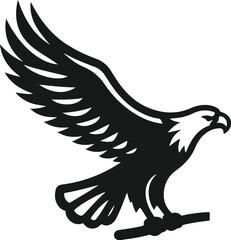 Majestic black silhouette of an eagle landing on a branch with wings spread