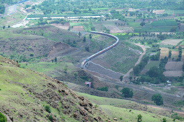 Passenger train hauled by a WAP7 electric locomotive near Pune India.