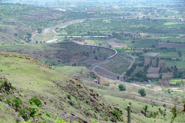 Passenger train hauled by a WAP7 electric locomotive near Pune India.