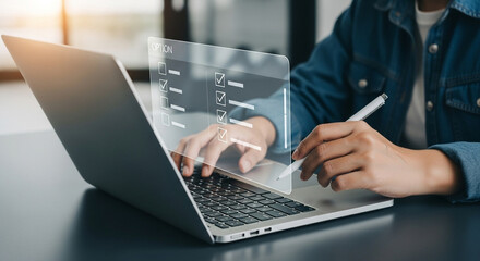 Person completing digital checklist on laptop with stylus in hand for online survey task focus