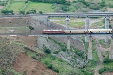 Passenger train hauled by a WAP4 electric locomotive near Pune India.