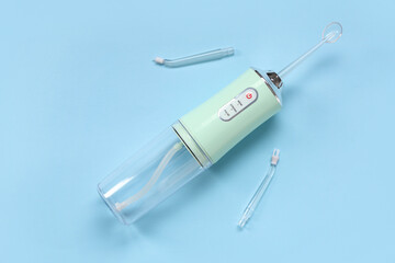 Oral irrigator with tubes on color background