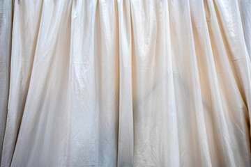 Obraz premium Close-up of a light fabric curtain, showcasing its folds and soft texture. Evokes privacy, comfort, and tranquility
