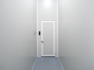 Scene of narrow corridor with finger scanner of entrance door room and passcode panel, modern door access control on white wall in industrial factory or warehouse. Fingerprint scan, security concept.