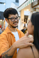 A man lovingly looks at a woman, he gently stroking her head
