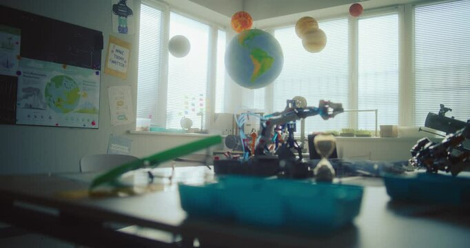 Modern Science Classroom with Hanging Solar System Models, 3D Printers, Robotic Arms and Renewable Energy Model Builder. STEM Learning Focused on Innovation, Exploration, Hands-on Technology Projects.