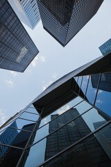 Flat design illustrating looking-up reflective glass towers with grid windows converging skyward